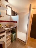 a small kitchen with a sink and a refrigerator at Gite pour pros entre Niort et Fontenay &#47; Tout compris in Benet
