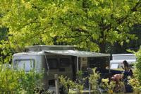 a horse is standing next to an rv at Camping La Mignardière in Ballan-Miré