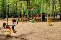 a playground with several different types of playground equipment at Camping La Mignardière in Ballan-Miré