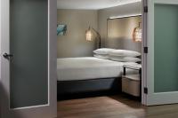 a bedroom with a bed with white sheets and pillows at Orlando World Center Marriott in Orlando