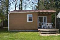 a small cabin with a table and chairs in it at Camping La Mignardière in Ballan-Miré