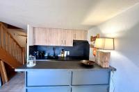 a kitchen with a black counter top in a room at Apartment with balcony and exceptional view in Saint-Gervais-les-Bains