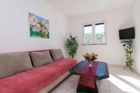 Televízia a/alebo spoločenská miestnosť v ubytovaní Apartments Glorija