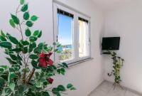 Televízia a/alebo spoločenská miestnosť v ubytovaní Apartments Glorija