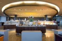 a restaurant with a large lobby with a bar at Atlantic Hotel Sail City in Bremerhaven