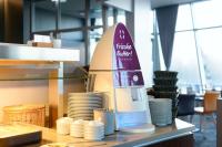 a food blender sitting next to a stack of plates at Atlantic Hotel Sail City in Bremerhaven