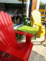 a red chair and a green table on a patio at Follow Me designed B&amp;B in Dongshan