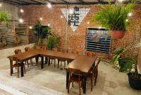 a dining room with wooden tables and potted plants at Follow Me designed B&amp;B in Dongshan