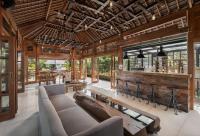 een woonkamer met een bank en een bar bij Paripadi Private Villa and Sanctuary in Canggu