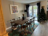 a dining room table with chairs and a christmas tree at Maison climatisée 155 m2+jardin in Puteaux