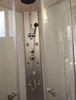 a shower in a bathroom next to a glass door at Le Studio de la Seine in Elbeuf