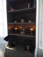a room with a shelf with candles and a desk at Le Studio de la Seine in Elbeuf