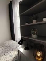 a bedroom with a bed and a lamp on a desk at Le Studio de la Seine in Elbeuf