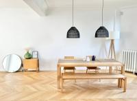 a living room with a table and a mirror at Maison familiale avec vue tour Eiffel in Suresnes