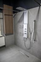 a bathroom with a shower with a sink and a shower at Hotel Guzy in Lier