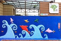 a blue wall with fish painted on it at Yu Sen House in Kenting