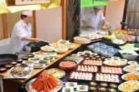 two chefs preparing food on a buffet table at Kurobe Kanko Hotel in Omachi
