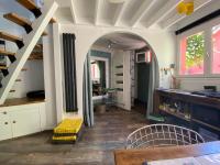 a kitchen with an archway and a table and chairs at charmante maisonnette in Le Havre