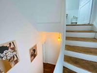 a hallway with stairs and pictures on the wall at Casa 64 in Angers