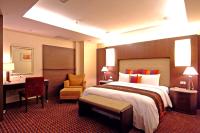 a hotel room with a large bed and a desk at Jingan Classic Inn in Zhonghe