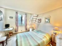 a bedroom with a bed and a desk and a staircase at La Marjolette by Welcome to Cannes in Cannes