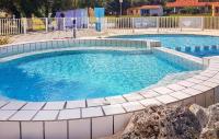 a large swimming pool with blue water at Lovely Home In Saint-savinien With Outdoor Swimming Pool in Saint-Savinien