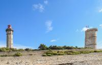 two towers on a hill next to a wall at Lovely Home In Saint-savinien With Outdoor Swimming Pool in Saint-Savinien