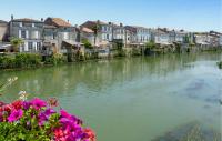 a view of a river with houses and flowers at Lovely Home In Saint-savinien With Outdoor Swimming Pool in Saint-Savinien