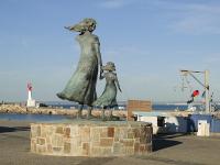 a statue of a woman and child near the beach at Studio Le Grau-du-Roi, 1 pièce, 4 personnes - FR-1-307-123 in Le Grau-du-Roi