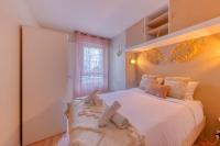 a bedroom with a large white bed and a mirror at La pépite bleue de Nanterre in Nanterre