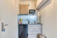 a small kitchen with a sink and a microwave at Le Cocoon, appartement à proximité du Vieux Marché in Rouen