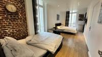 a room with two beds and a brick wall at Gorgeous Paris Eiffel Tower in Paris