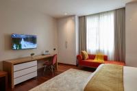a hotel room with a bed and a desk at Deerpark Luxury Stays in Nairobi