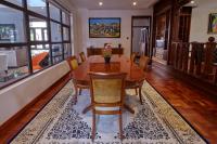 a dining room with a wooden table and chairs at Deerpark Luxury Stays in Nairobi