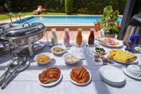 a table topped with plates and bowls of food at Deerpark Luxury Stays in Nairobi