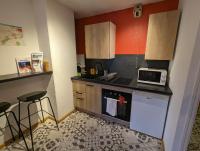 a small kitchen with a stove and a microwave at Ton Petit Studio - Le 62 - Coeur de Ville in Mulhouse