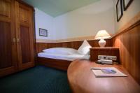 A bed or beds in a room at Gasthof Hotel Zweimüller