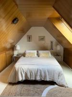 a bedroom with a large bed in a attic at Ty glaz in Ploubazlanec