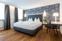 A bed or beds in a room at Gasthof Hotel Zweimüller