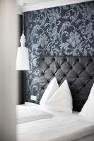 A bed or beds in a room at Gasthof Hotel Zweimüller