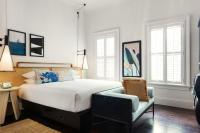 a bedroom with a large bed and a chair at Ridley House - Key West Historic Inns in Key West