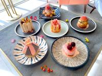 a table topped with plates of cakes and pastries at Uni-Resort Ku-Kuan in Heping