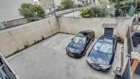 two cars are parked in a parking lot at Chic apart with parking and balcony near Paris in Aubervilliers