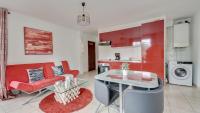 a living room with a red couch and a glass table at Chic apart with parking and balcony near Paris in Aubervilliers