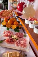 una mesa cubierta con diferentes tipos de comida en platos en My Home Hotel, en Bellaria-Igea Marina