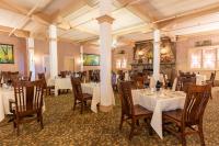 a dining room with white tables and chairs at Historic Summit Inn in Farmington