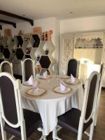 a dining room with a white table and chairs at Quinta de VillaSete in Alpendurada