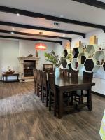 a dining room with a table and chairs and a fireplace at Quinta de VillaSete in Alpendurada