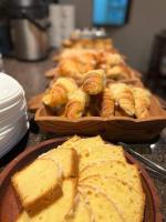a table topped with plates of bread and pastries at Hotel Astur in Salta