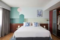 A bed or beds in a room at voco Madrid Retiro by IHG